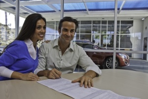 Couple signing auto contract